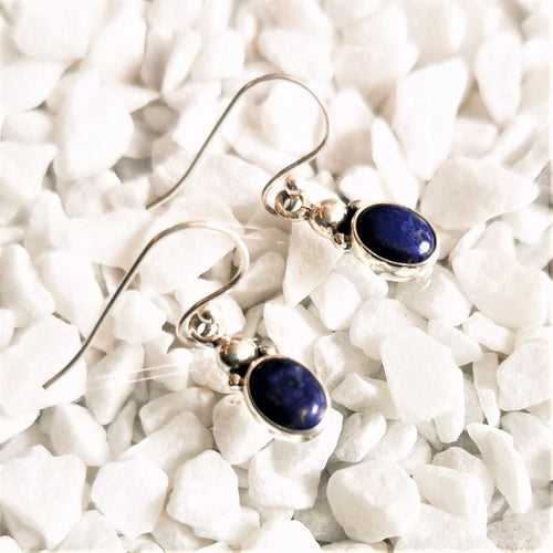 Blue lapis lazuli ovals set in silver as drop earrings with silver ball details at top